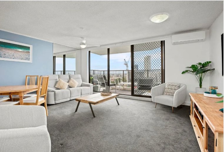 Light-filled lounge and dining area with balcony views